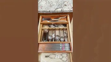 Utensil drawer with sliding trays.
